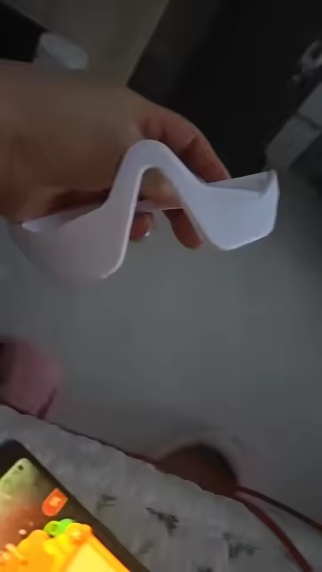 Side profile of Eye Massager held in hand