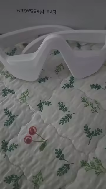 Eye Massager placed on patterned fabric
