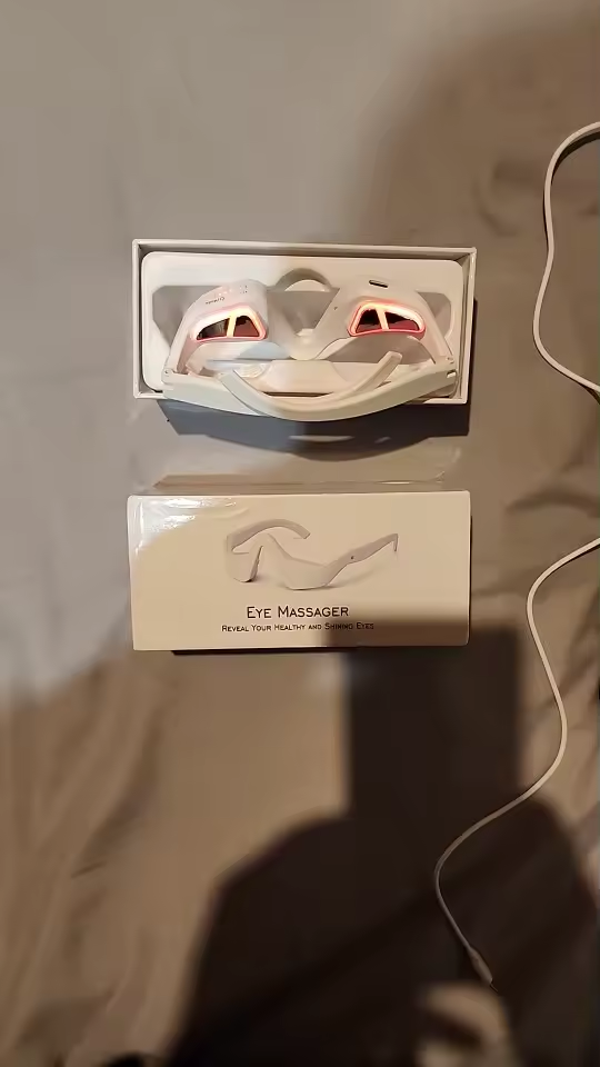 Top-down product photo of Eye Massager with the box